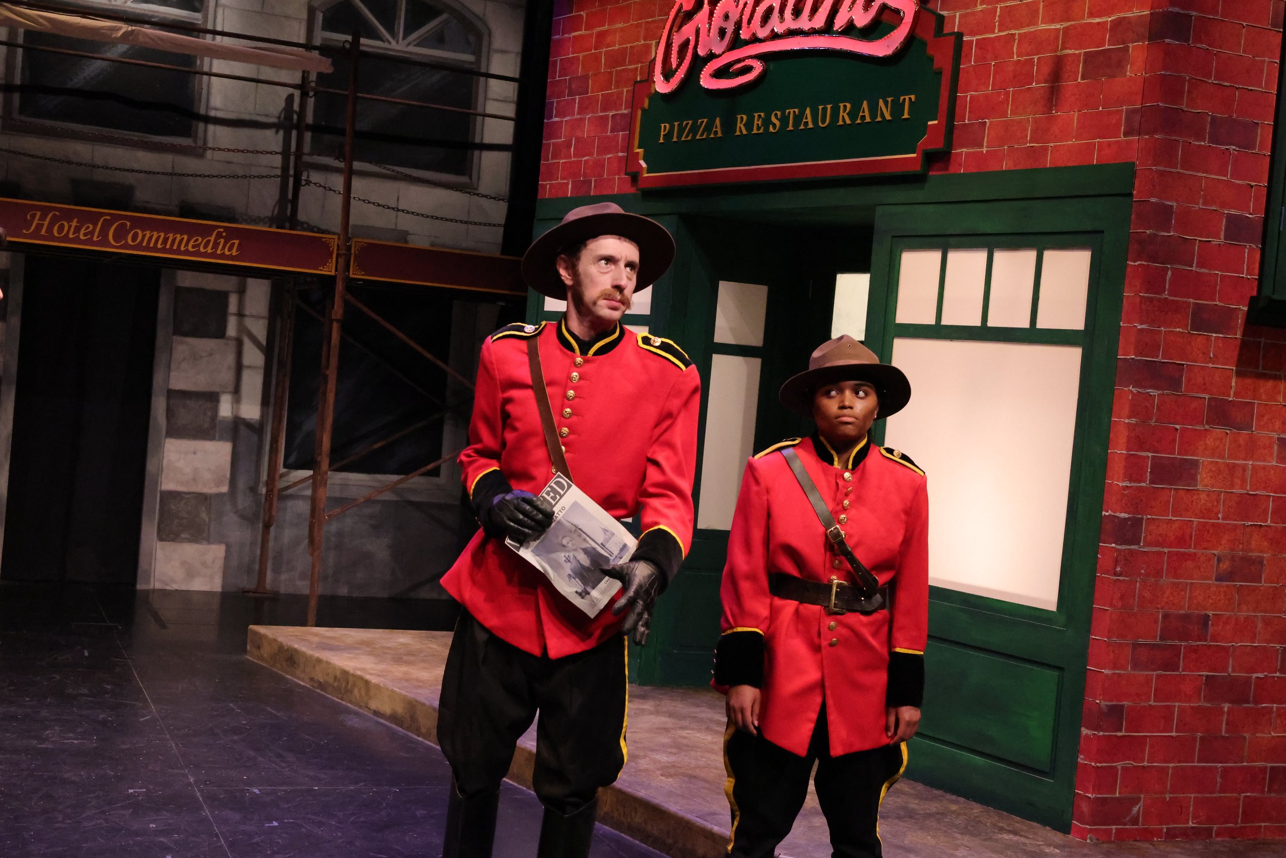 Chief Inspector Jaques Dudlee du Penistete holds a wanted poster for Furio Berzatto