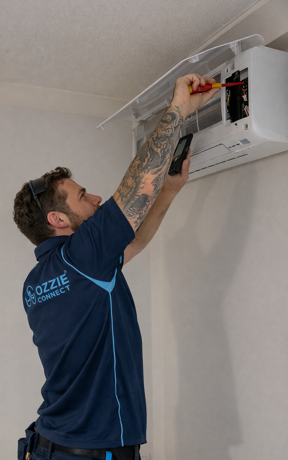 Technician repairing a wall-mounted air conditioner unit in a home.