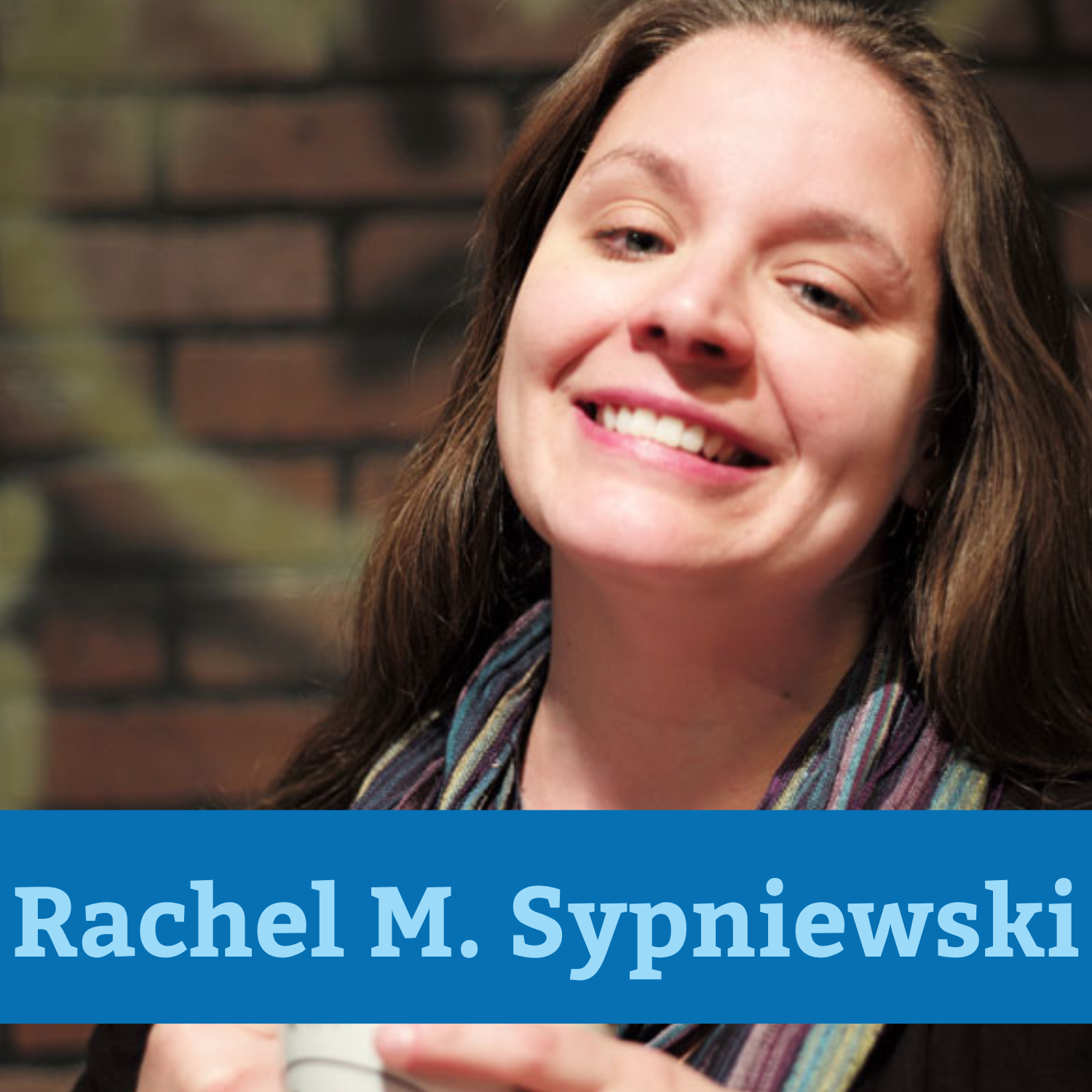 Smiling woman with brown hair with the text "Rachel M. Sypniewski" in blue over top