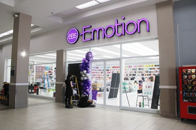 Storefront of EDS Emotion with purple and silver balloons outside, shopping carts, and customers inside.