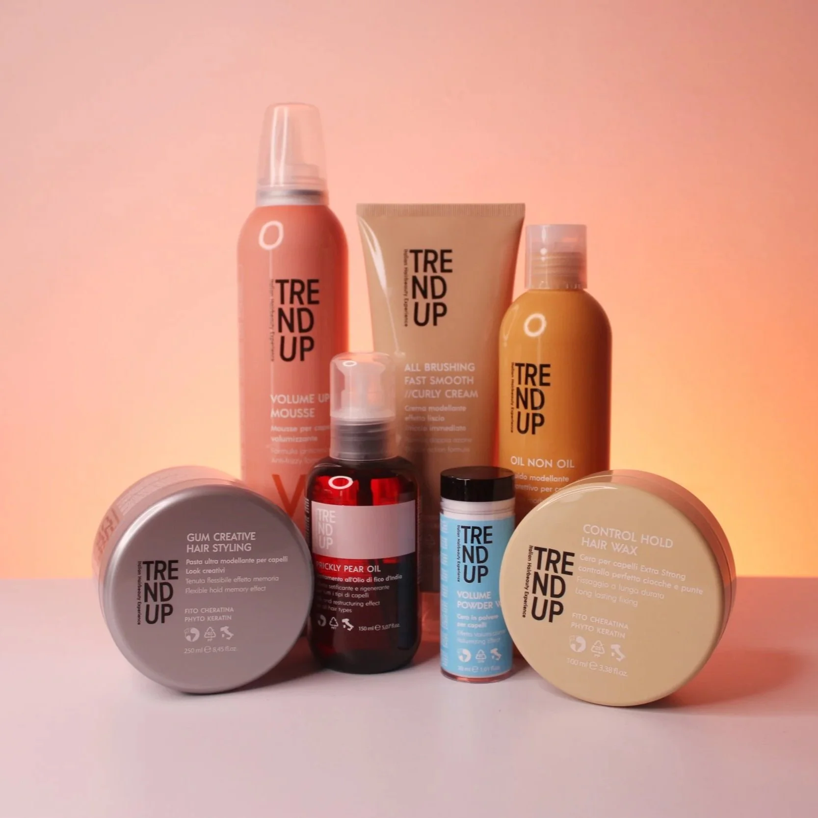 Collection of hair styling products including mousse, curl cream, oil, hair wax, volumizing powder, and pear oil, all labeled with 'TREND UP' brand.