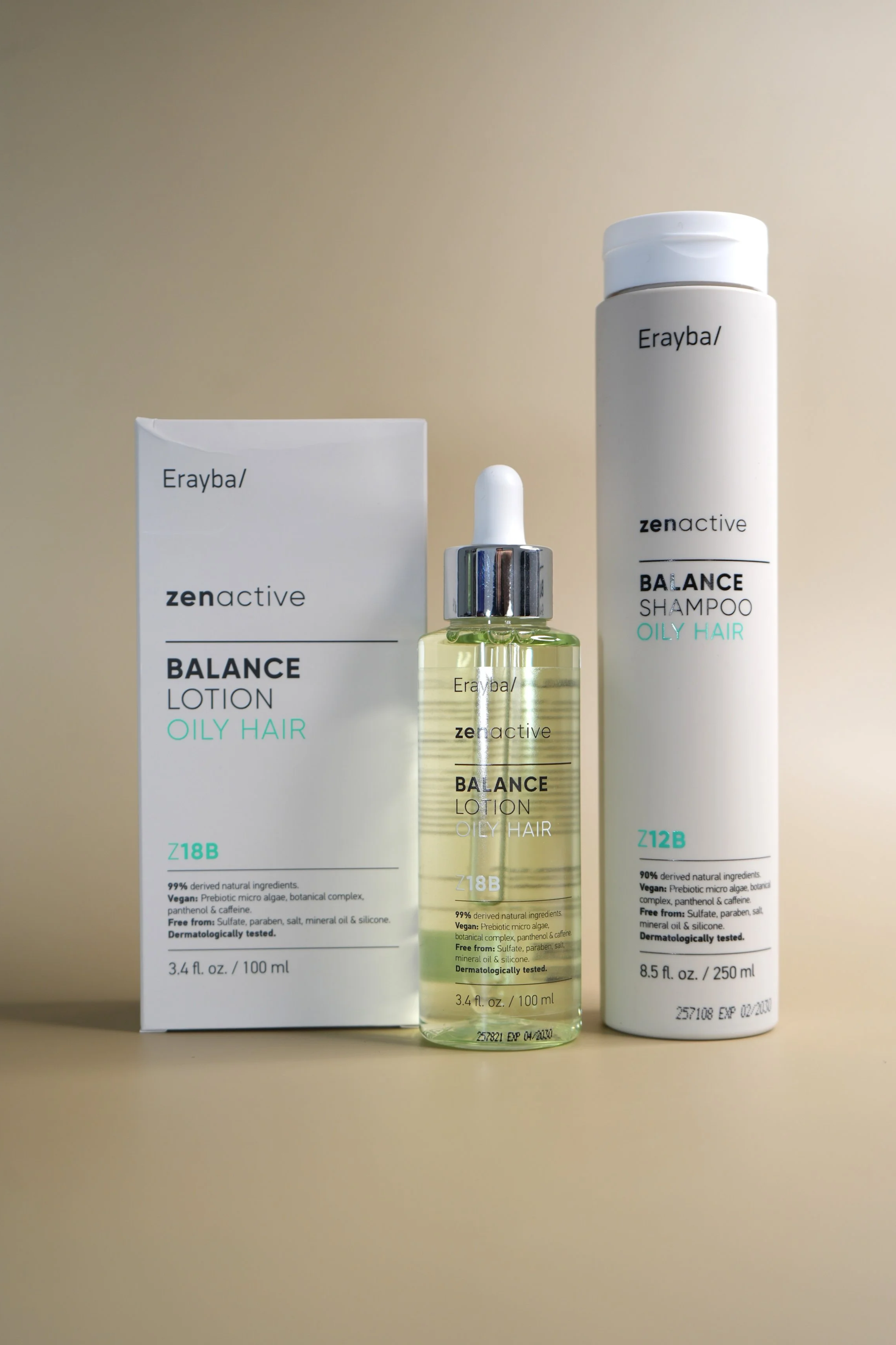 Three hair care products for oily hair: a box of balance lotion, a dropper bottle of balance lotion, and a tall bottle of balance shampoo.