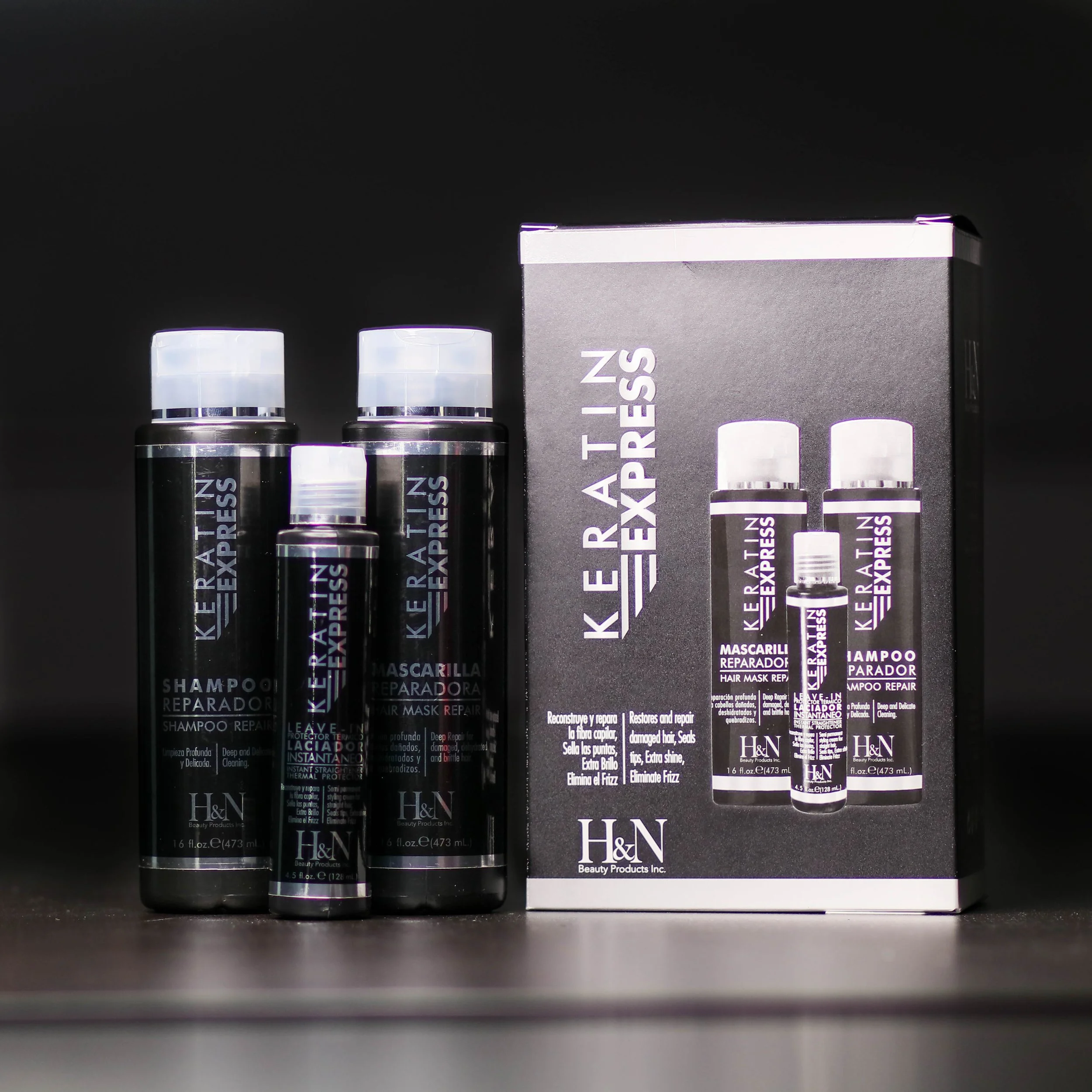 Set of hair care products including shampoo, hair mask, and leave-in conditioner from Keratin Express, in black bottles with white caps, alongside product packaging.