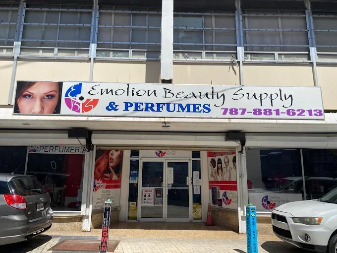 Signboard for Emotion Beauty Supply & Perfumes store with a photo of a woman’s eye, store name, phone number, and images of women and perfume bottles in the window.
