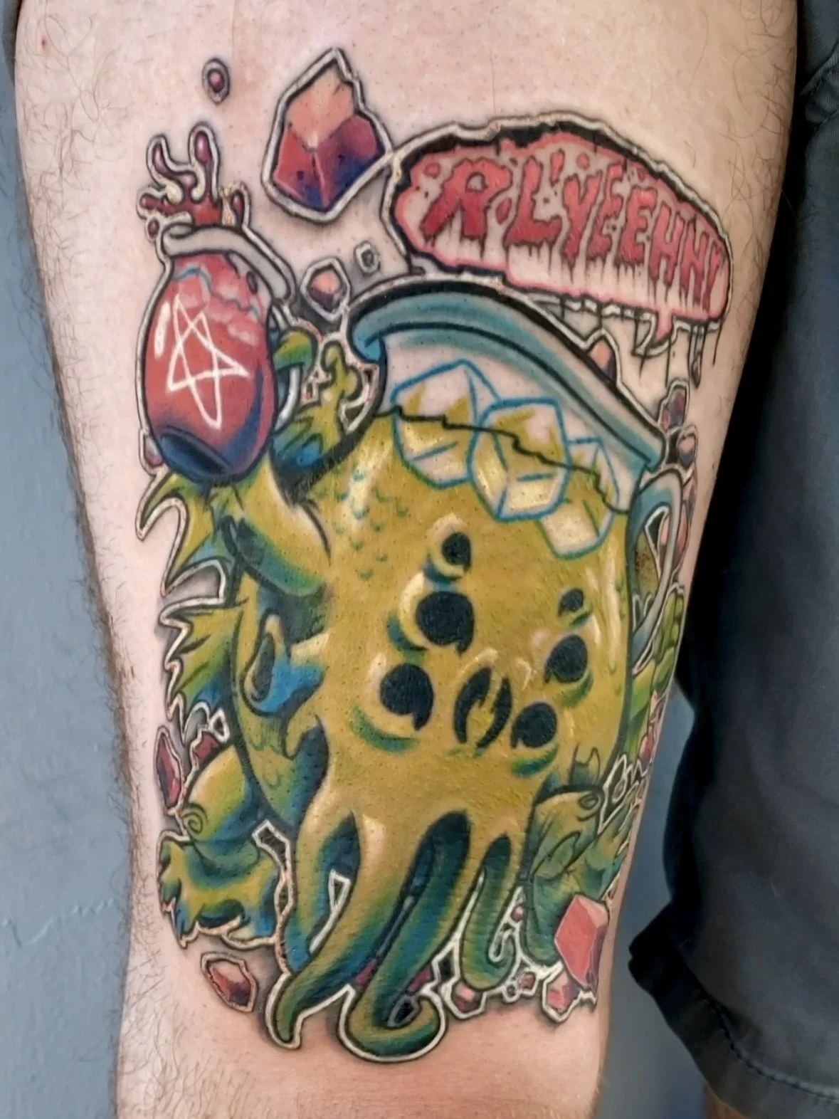 A colorful tattoo featuring a brain with a virus DNA strand, a syringe, a heart with a symbol, and a banner with the text 'LYSLEYHND'.