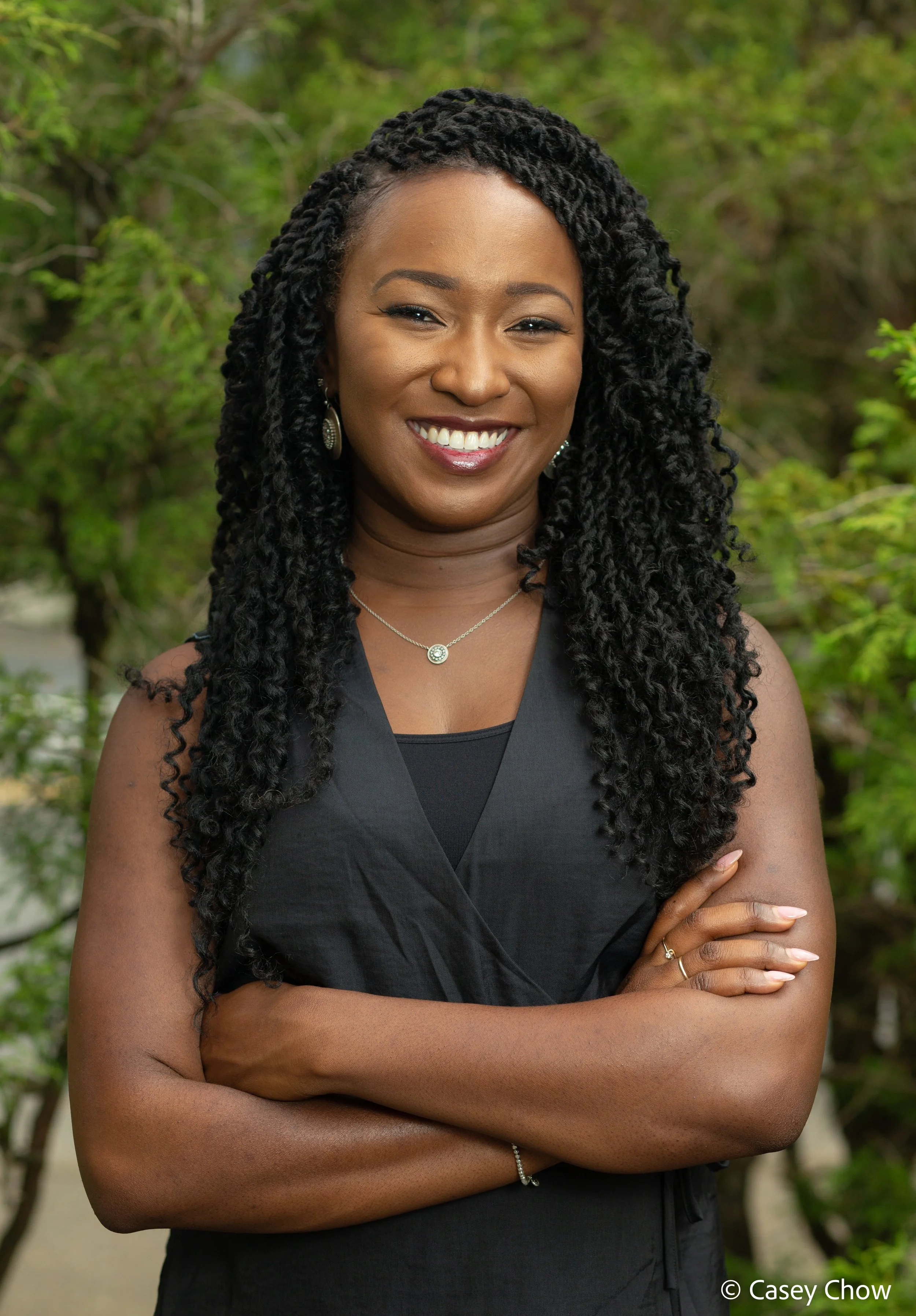 Dr. Page smiles at the camera with arms crossed