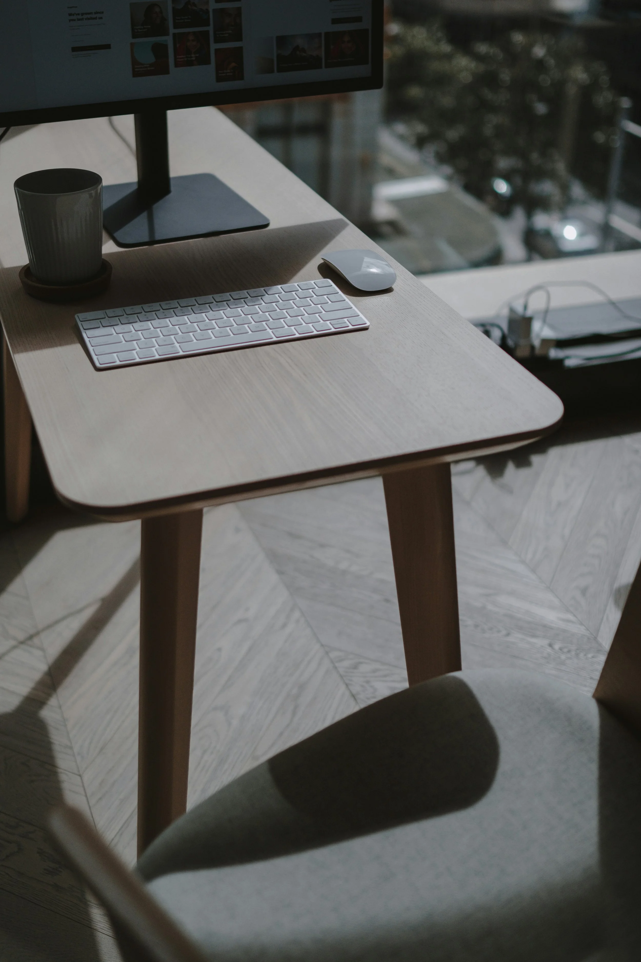 A desk with computer overlooking the city