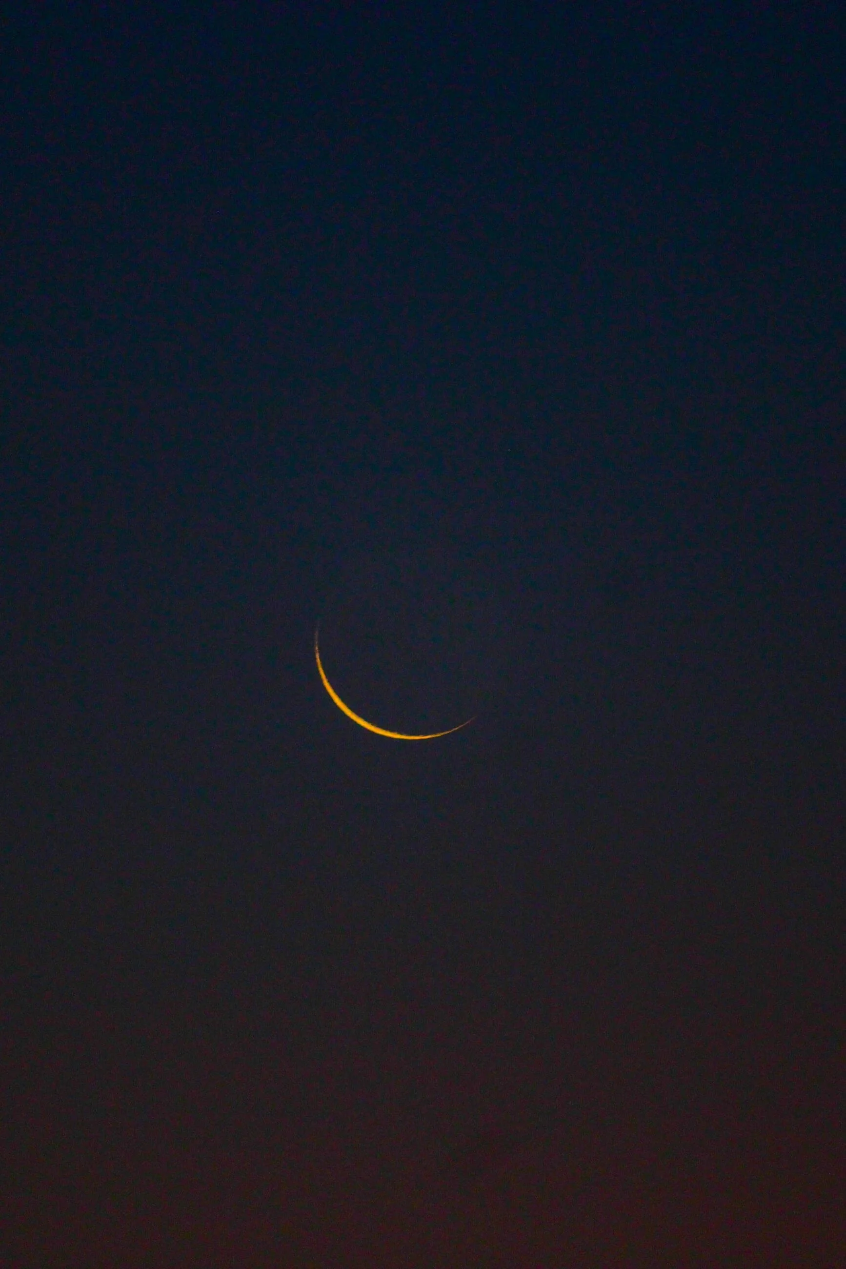 A moon sliver in the night sky