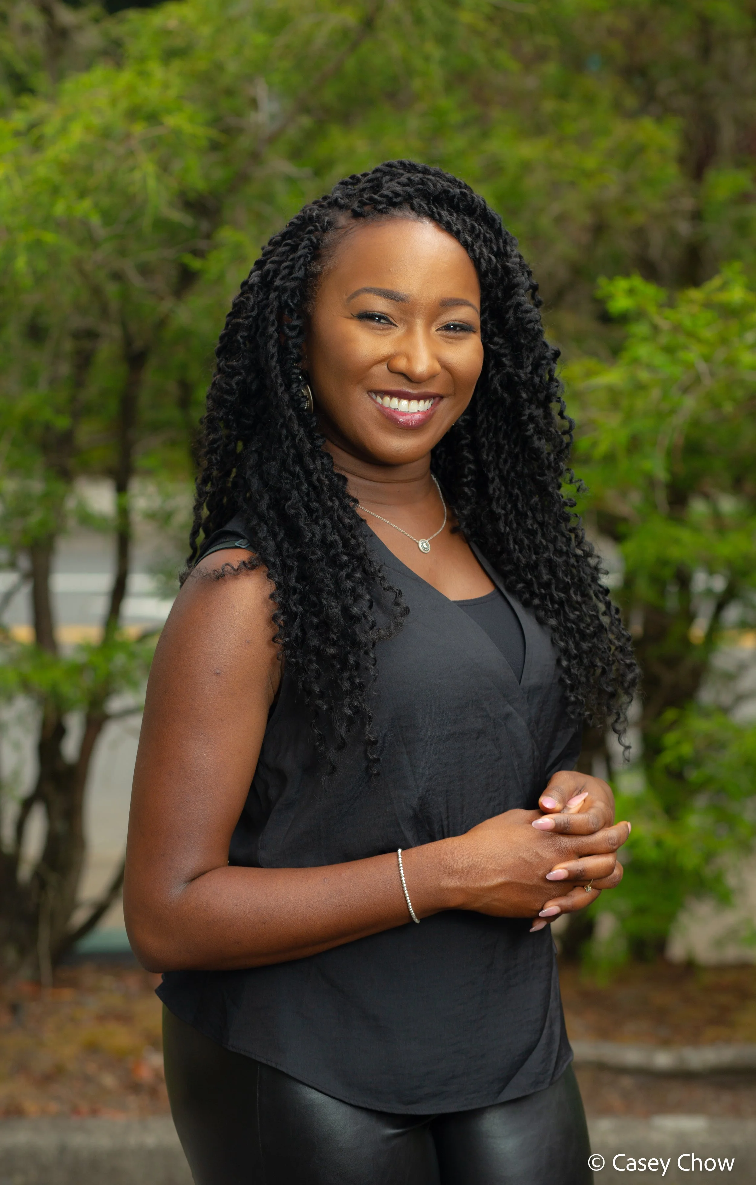 Unique stands outside in charcoal outfit