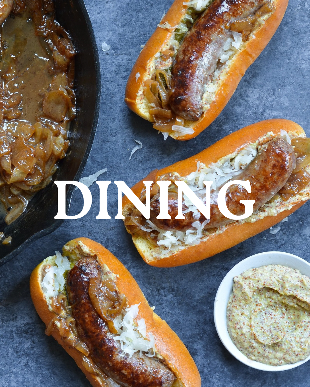 Ariel view of bratwursts with sauerkraut and mustard.