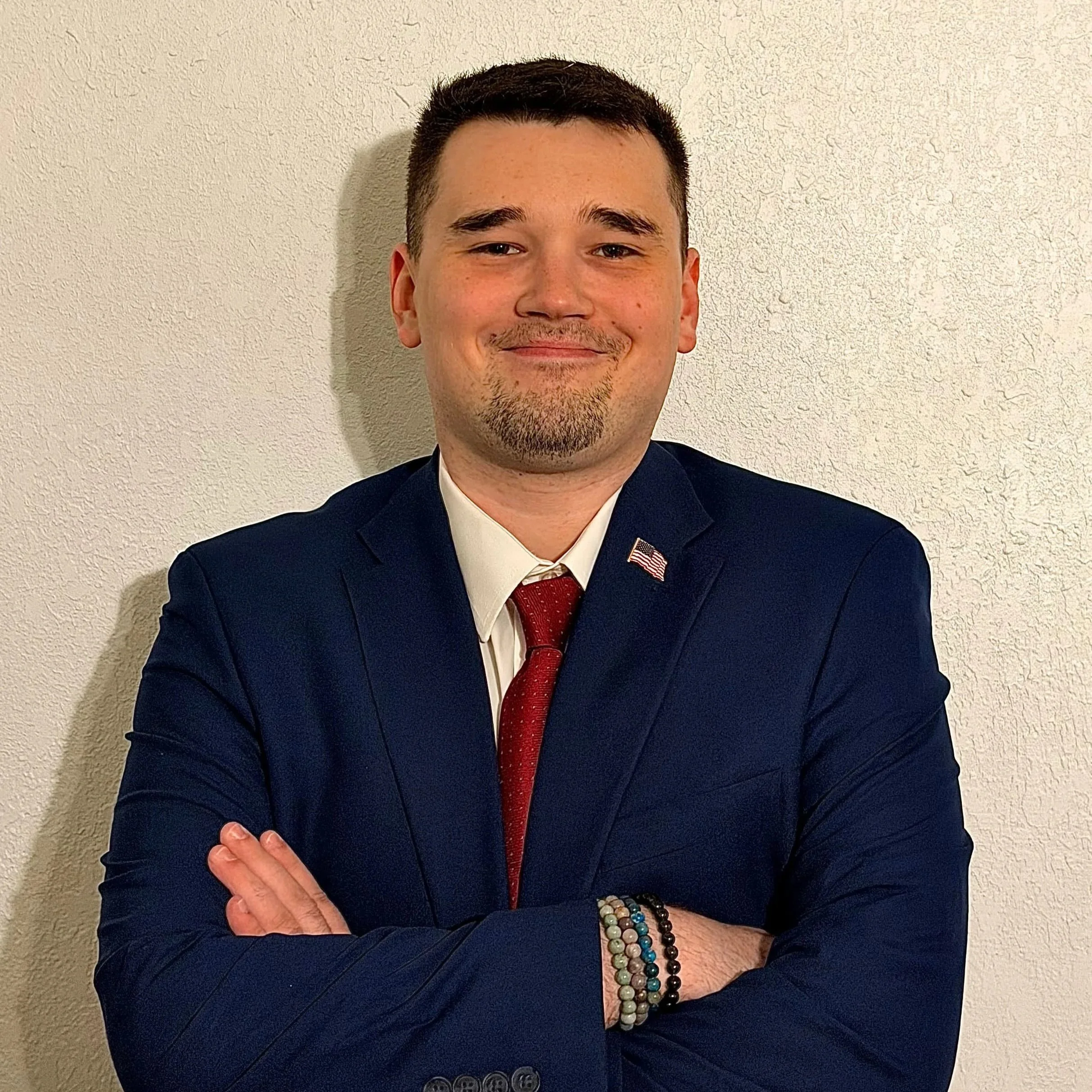 Grayson Hunt, US Politician, Portrait Photo with Suit and Tie and Flag Pin.