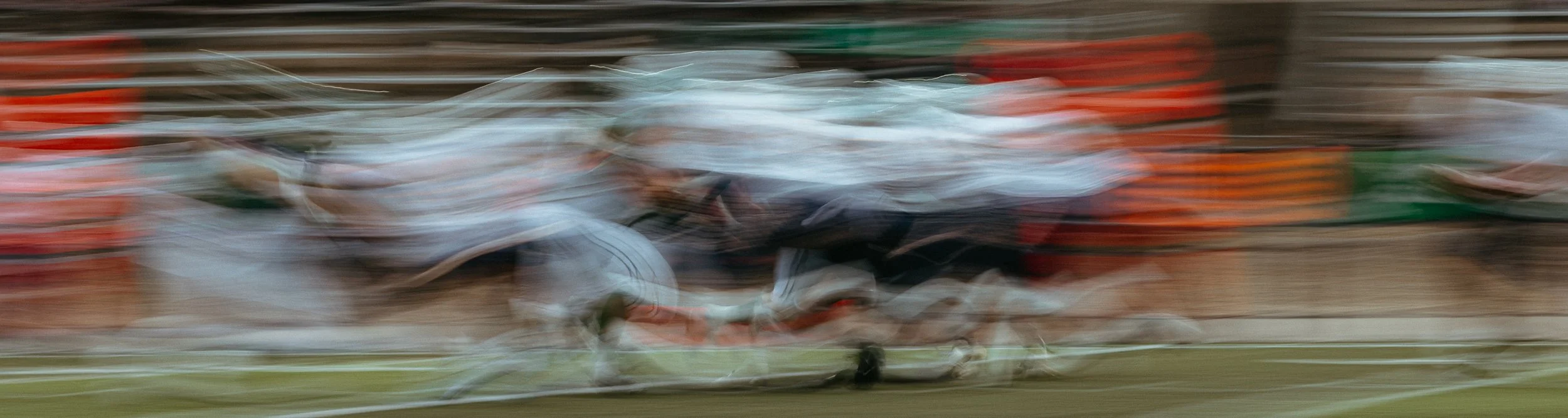 Blurry image of horses racing.