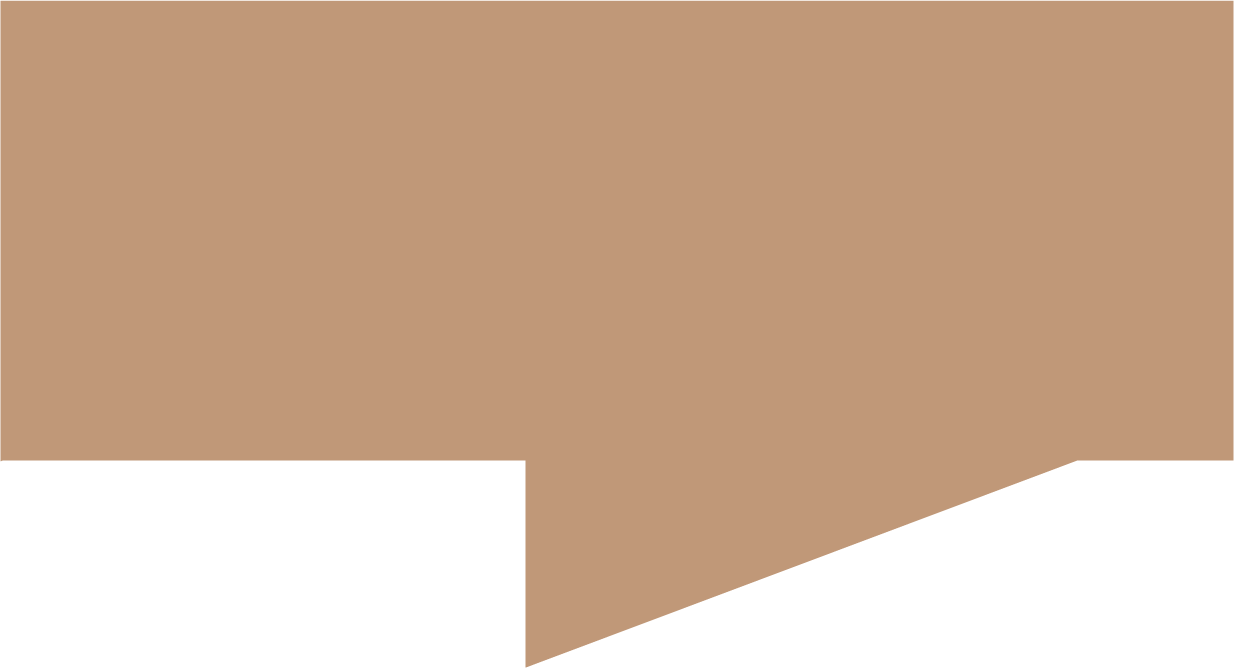 Close-up of a person holding a makeup brush applying blush to their cheek.