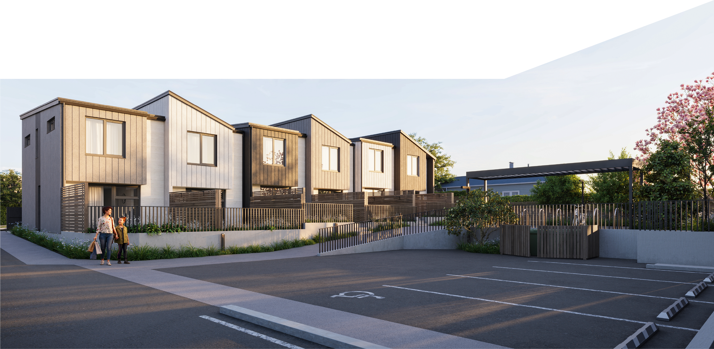 Modern residential building with townhouses, outdoor parking area, and landscaped greenery, during daylight. Northgate Estate, New Plymouth,