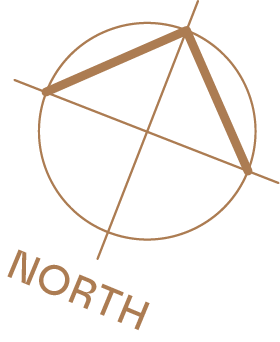 A geometric compass with a protractor and ruler inside a circle, pointing North.