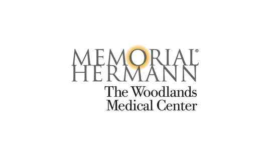 Memorial Hermann The Woodlands Medical Center logo with text and a gold ring symbol.