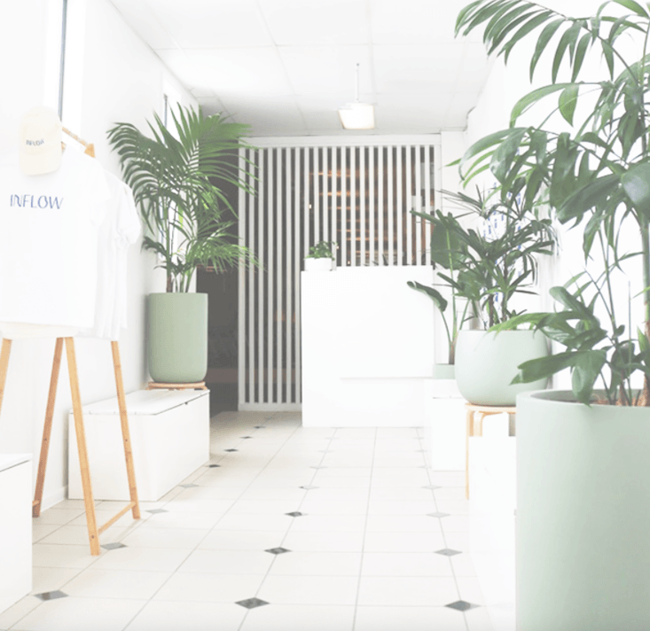 pilates studio reception transformation featuring sage pots and styled plantts