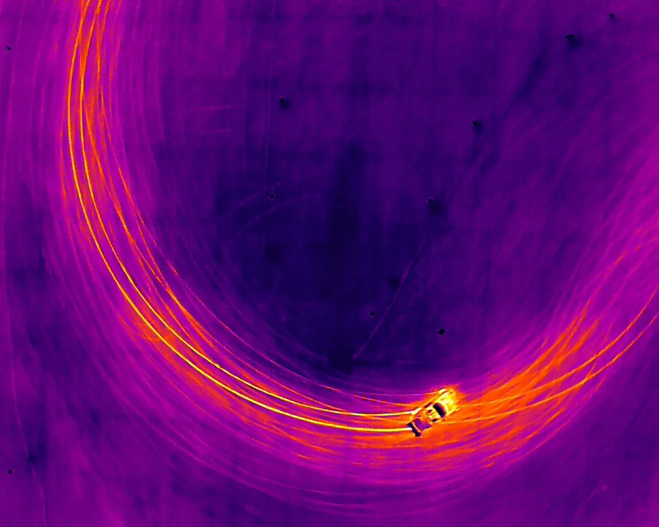 An infrared photo of drifting cars at nola motorsports. The heat from the tires can be seen on the thermal camera and the result is each driver creating infrared brushstrokes with each line they take.
