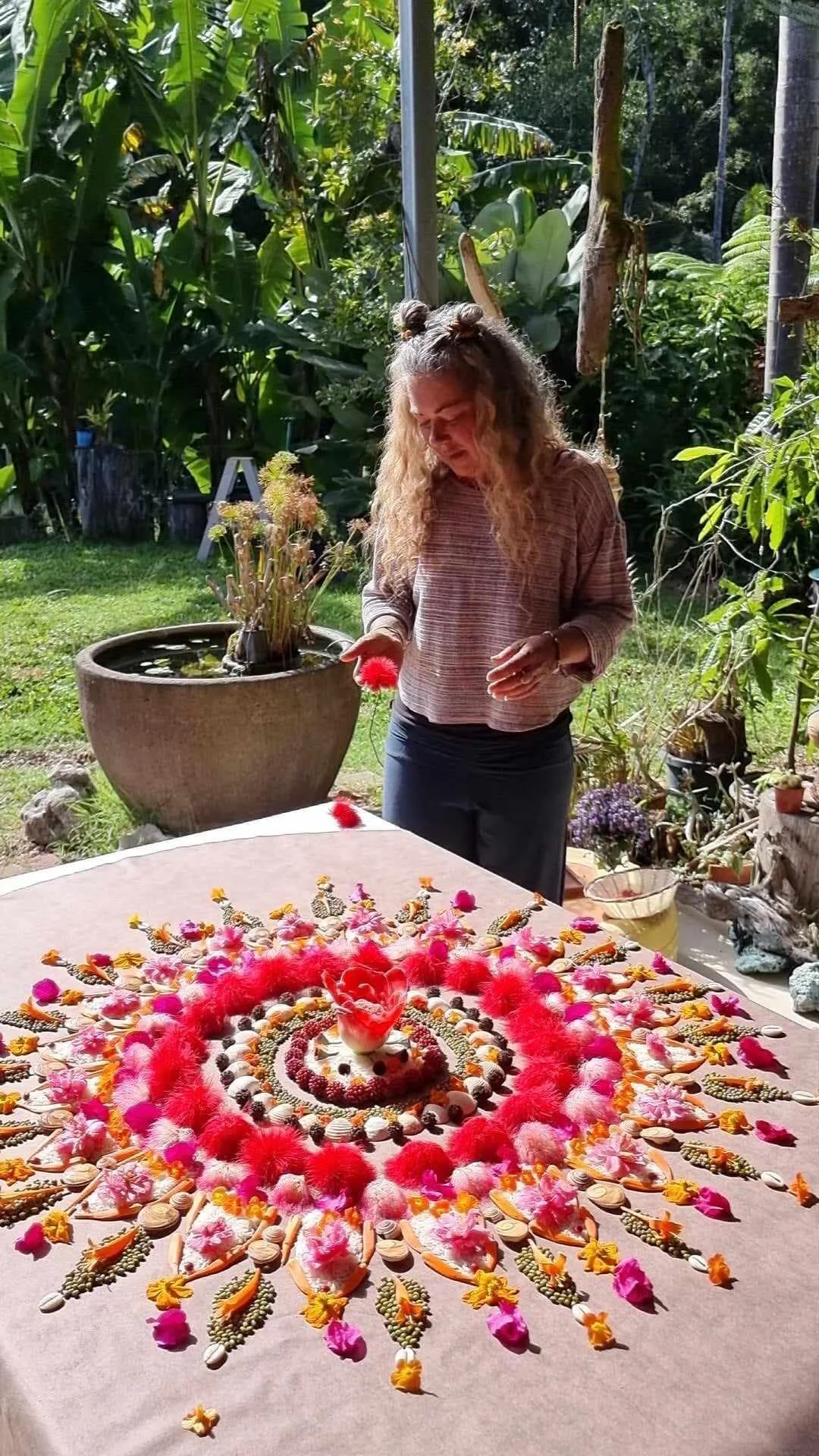 Woman creating a flower mandala. Image courtesy Holli Scius
