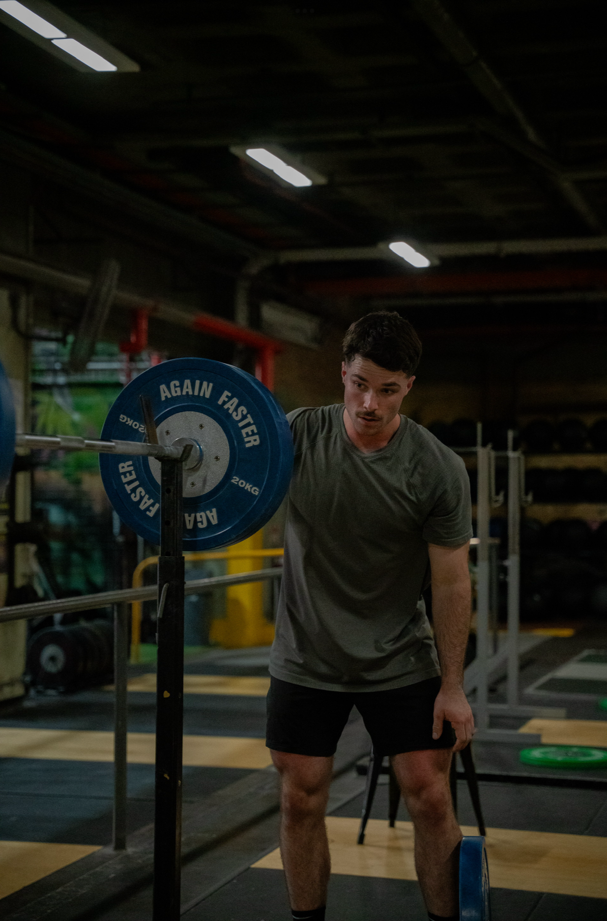 Sports Chiropractor Putting Weights on a Barbell For Rehab