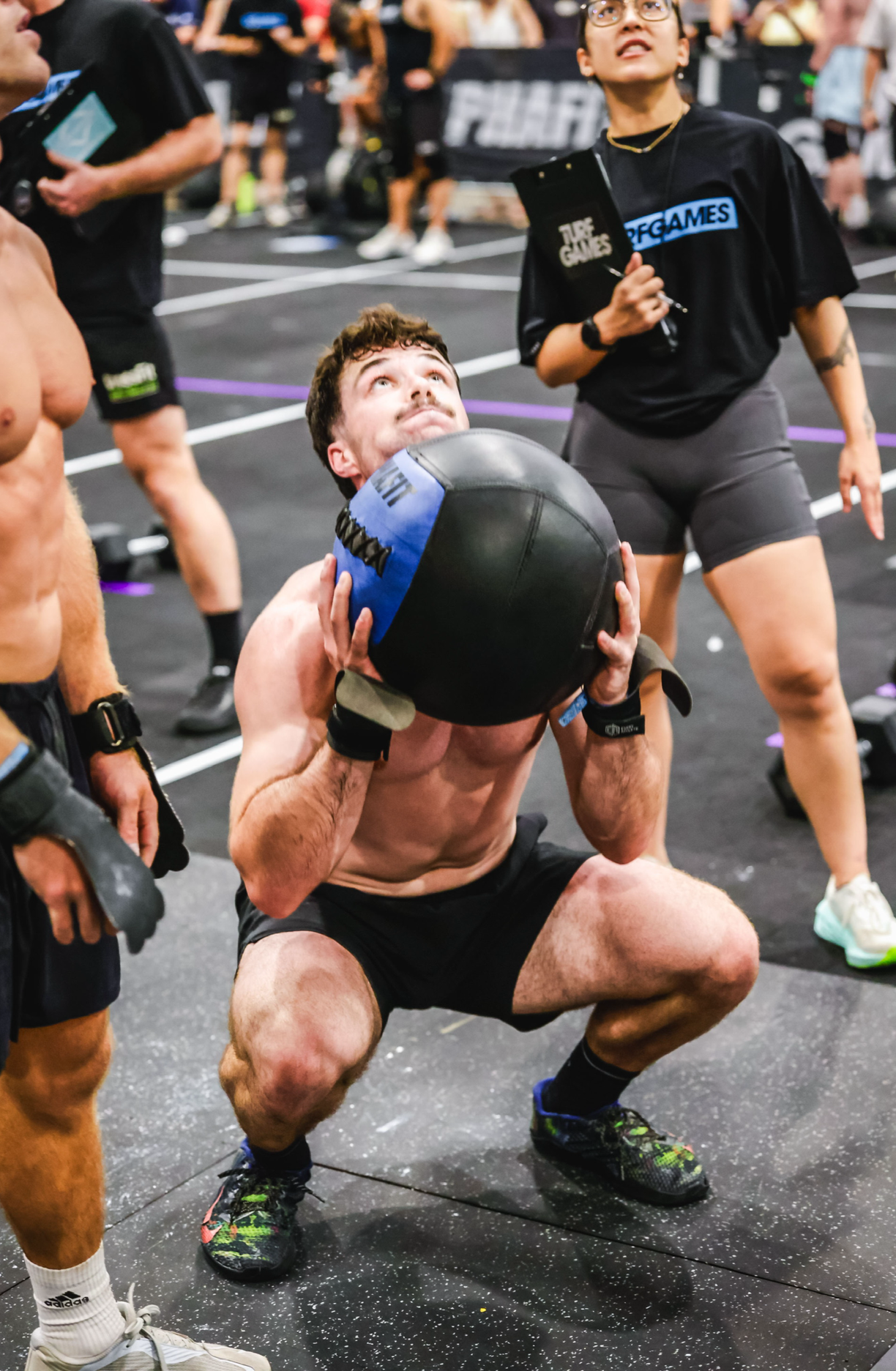 Sports Chiropractor Squatting With a Weighted Wall Ball 