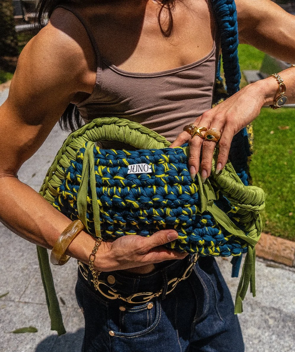 Model wearing one of a kind Juno Limited Bag with green and blue colours.