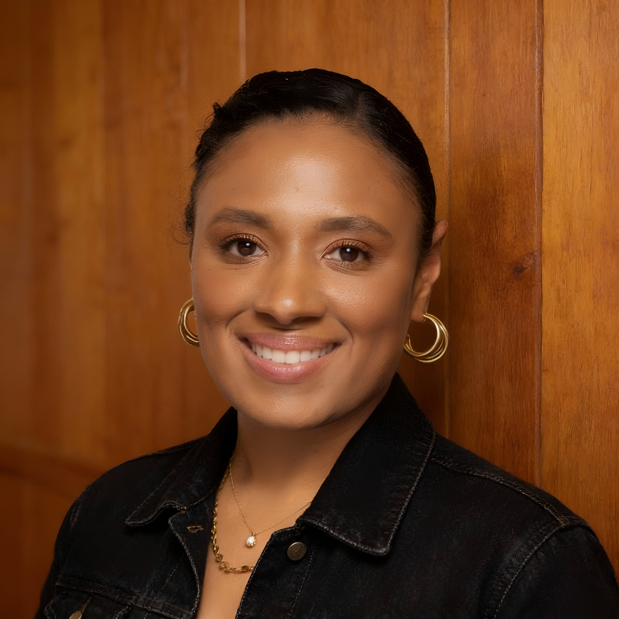 Pattern of black semi-circles and quarter-circles on a beige background arranged in a repetitive design.