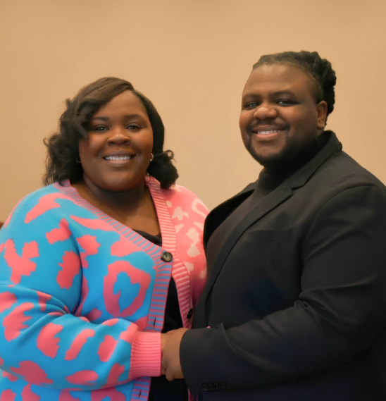 A pattern of black semi-circles and quarter circles on a beige background.