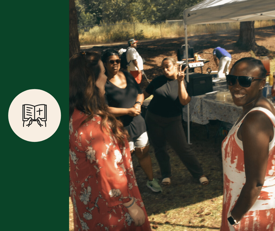 Group of women socializing outdoors at a daytime gathering with a tent and food table in the background.