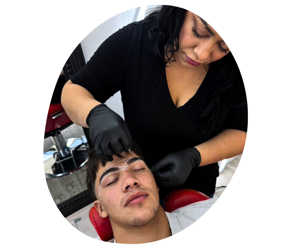A before wax image of a woman with black hair and black gloves mapping, designing a brow shape to a man lying down with closed eyes in a salon.