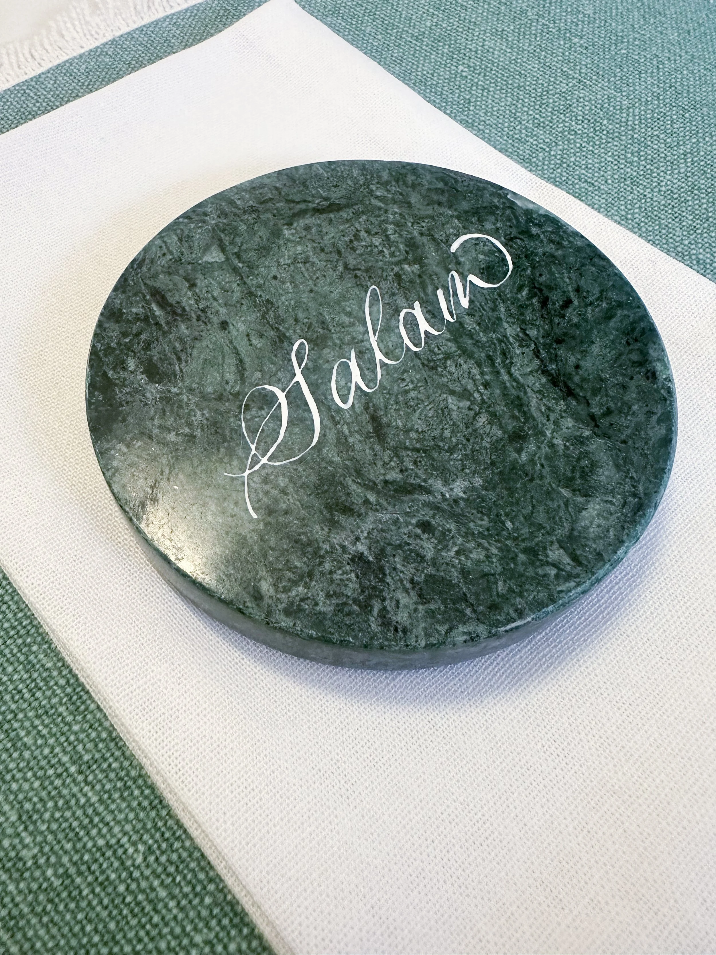 Round dark green stone with the word 'Galam' written in white, cursive lettering.