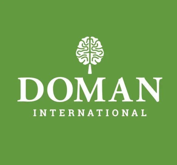 Green background with a white logo of a brain combined with a pencil and the text 'Doman International'.