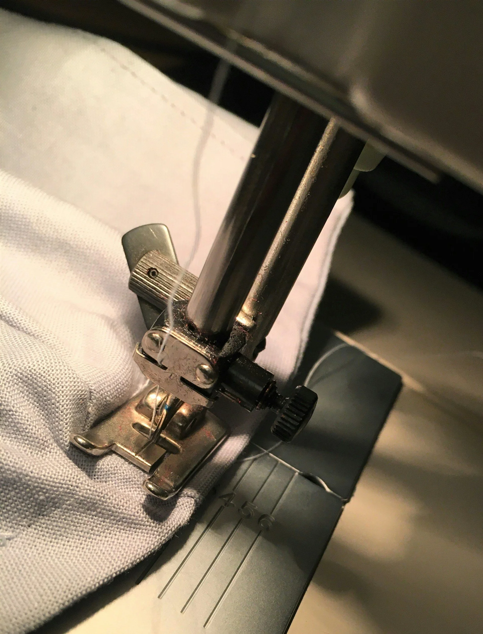Close-up of industrial sewing machine used for precise garment stitching and apparel assembly.