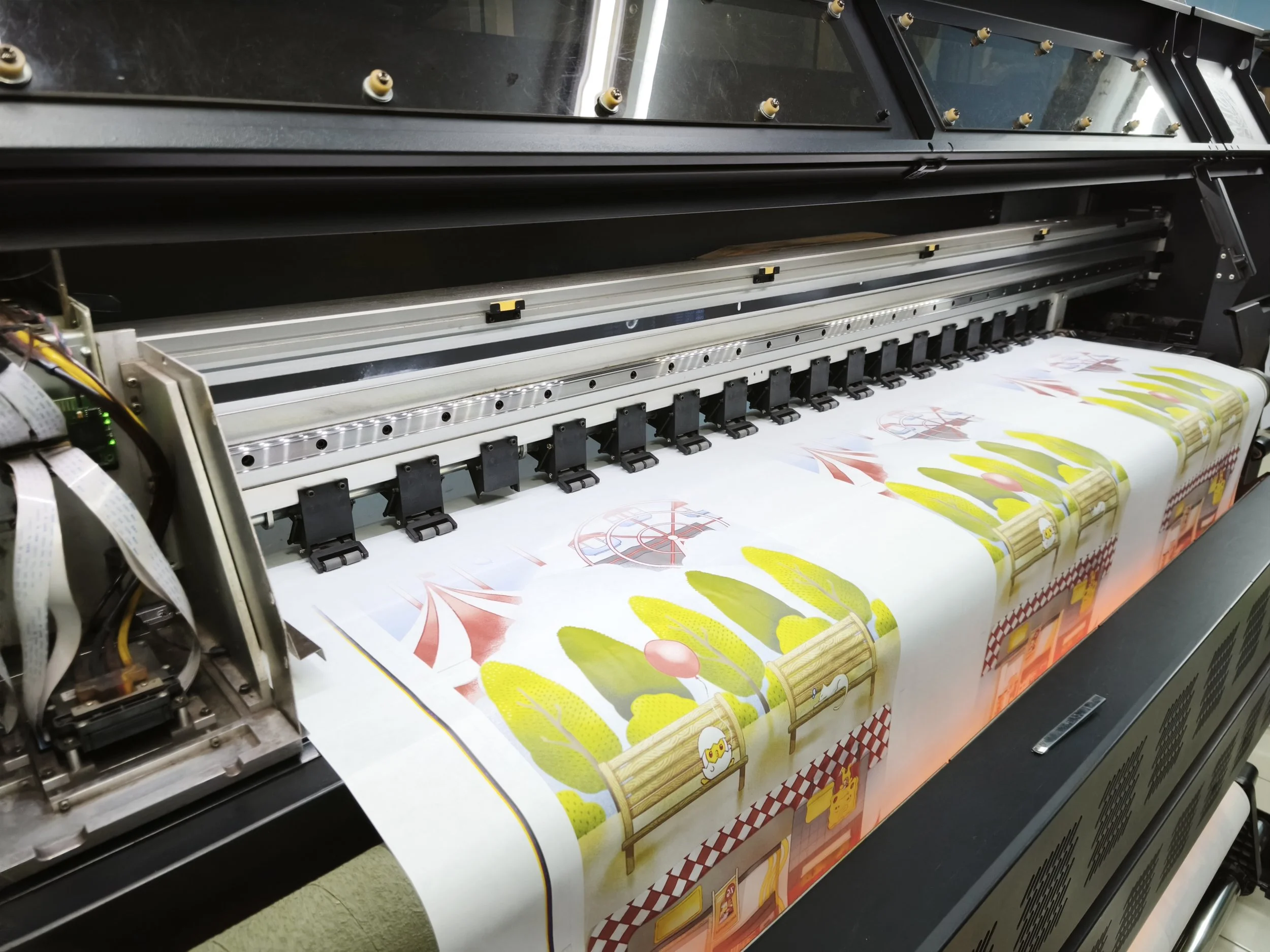 Large-format sublimation printing machine producing consistent, colour-accurate textile prints for apparel production.