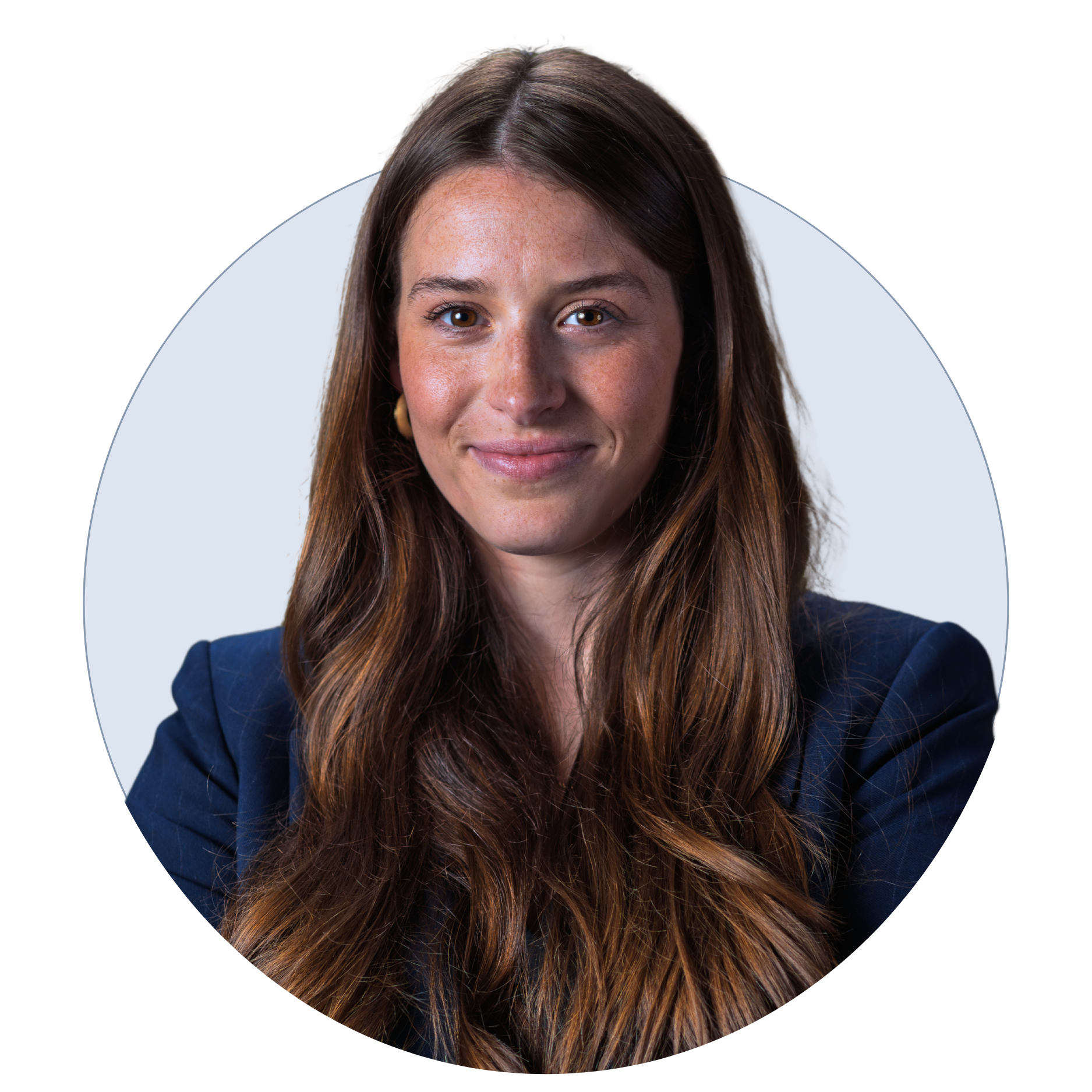 Portrait of a young woman with long brown hair smiling against a light background.