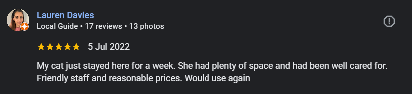Screenshot of a Google review by Lauren Davies, dated July 5, 2022, praising a place where her cat stayed for a week, mentioning friendly staff and reasonable prices.