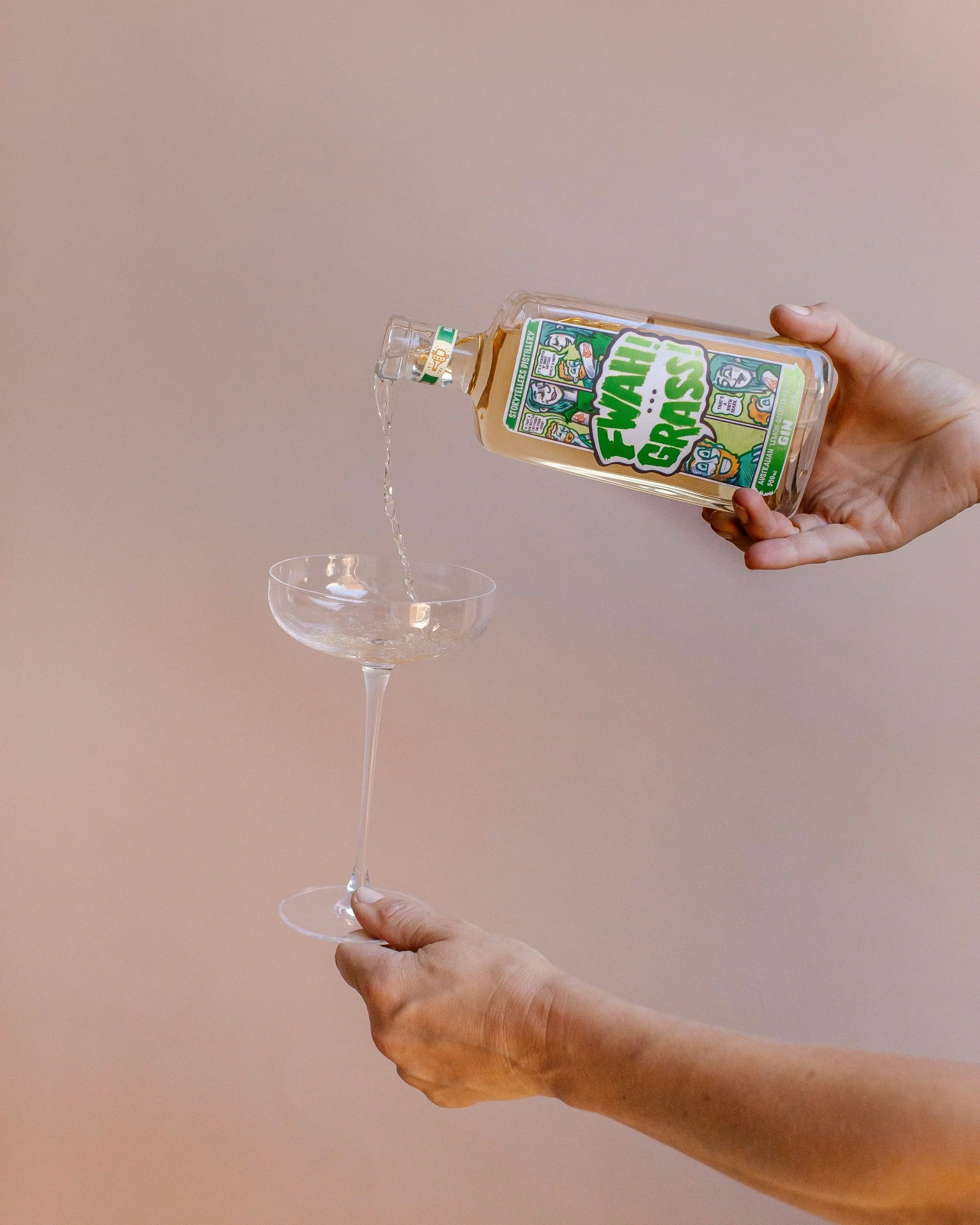 Storytellers Distillery bottle of  gin pouring into a cocktail glass