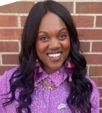 Three circular badges display ownership information: the first badge reads 'Woman Owned,' the second reads 'Black Owned,' and the third reads 'Queer Owned.' Each badge has a gold banner with the word 'Majority,' except the Queer Owned badge which has '100%.'
