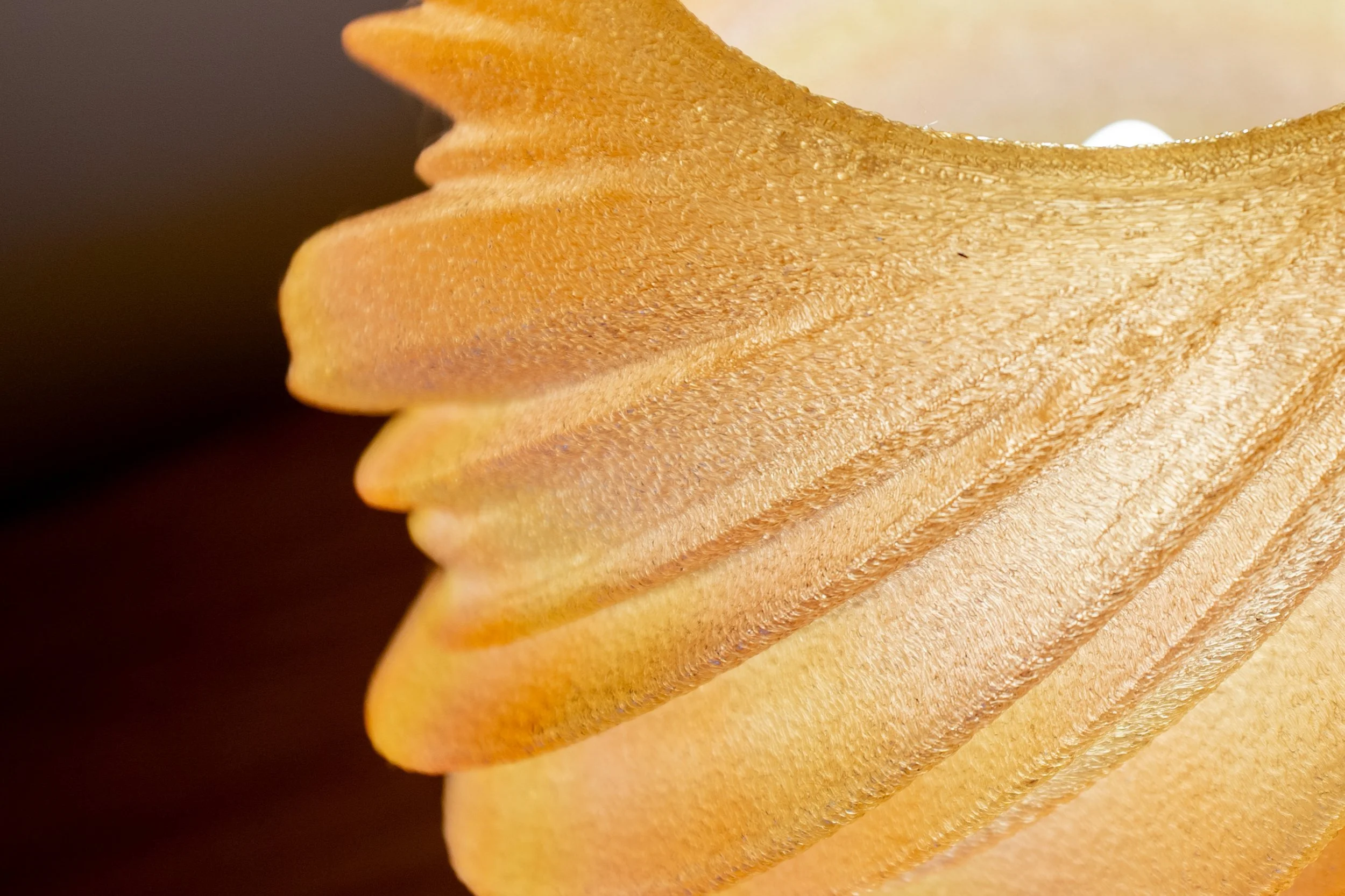 Close-up of a 3d printed lamp, with a  wooden spiral geometry and a detailed grain and texture.