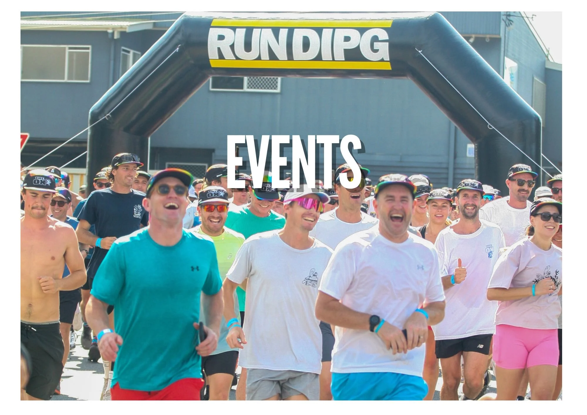 A group of people participating in a running event, passing under a large inflatable archway with the text 'RUNDGP' on it. The scene appears joyful and energetic.
