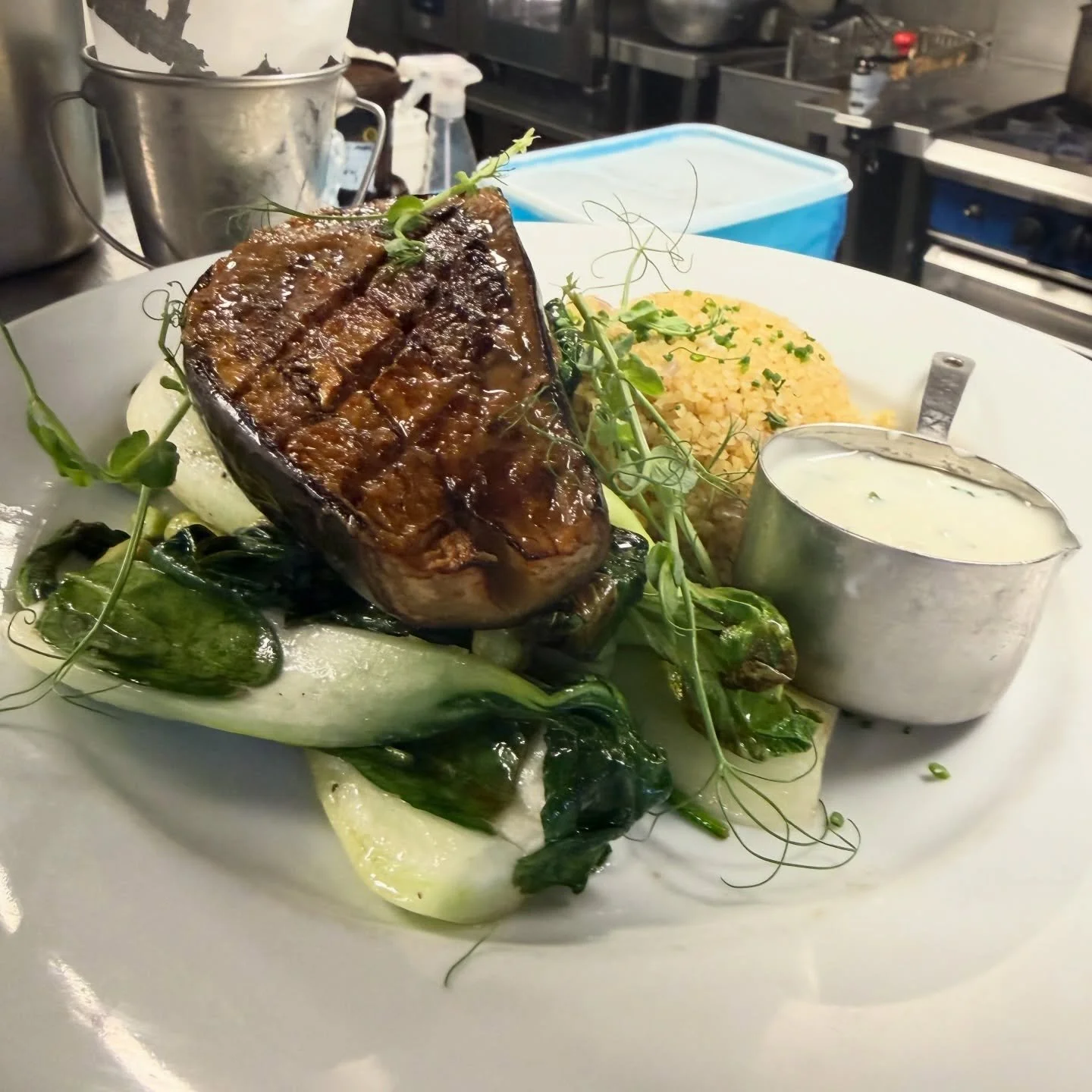 Miso glazed aubergine steak, herby bulgur wheat, miso soy ketchup, wilted choi, coriander yoghurt

#georgeanddragonchipstead 
#kentgastropub 
#modernbritishfood 
#vegetarianfoodie 
#foodworthtravelingfor