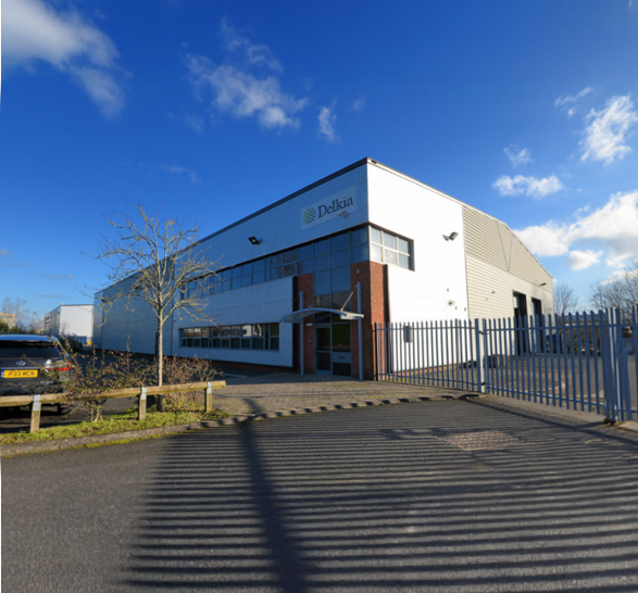 Classic warehouse style building on a sunny day - Delkia logo prominently placed above door/office end of building.