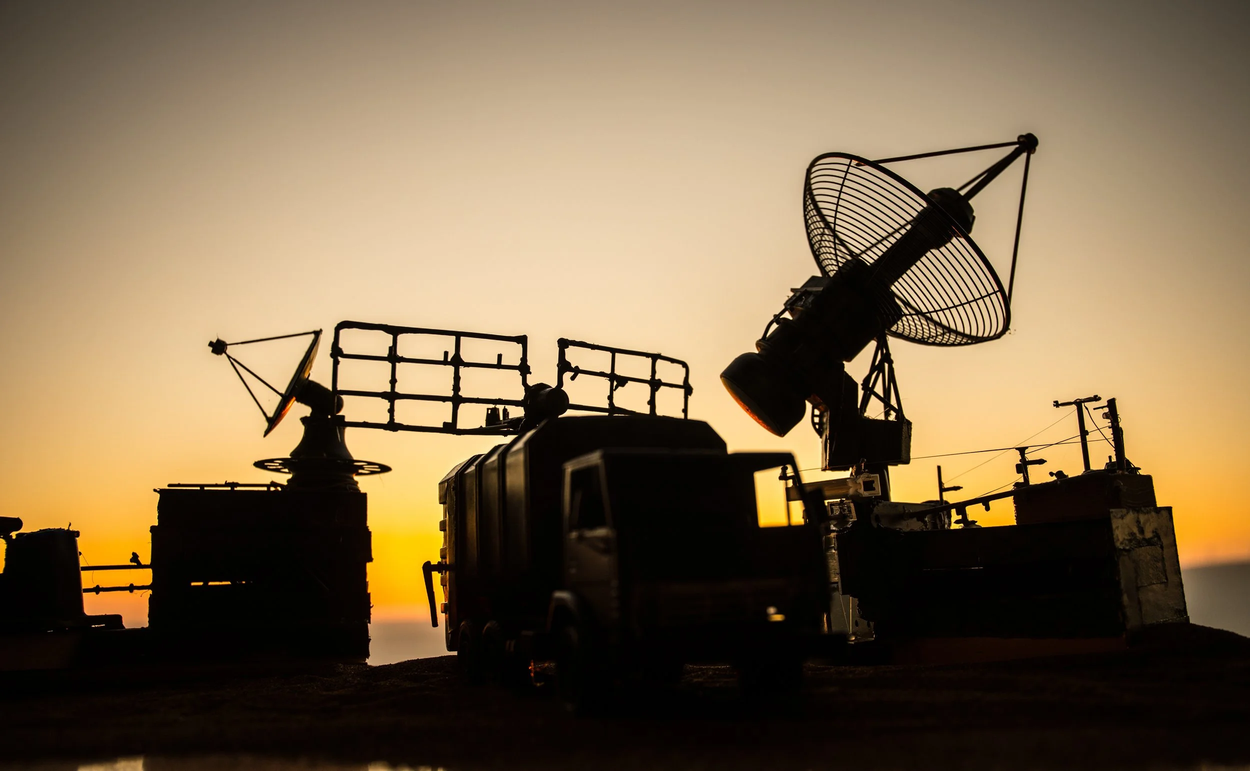 Artwork showing silhouette of radar equipment against sunset