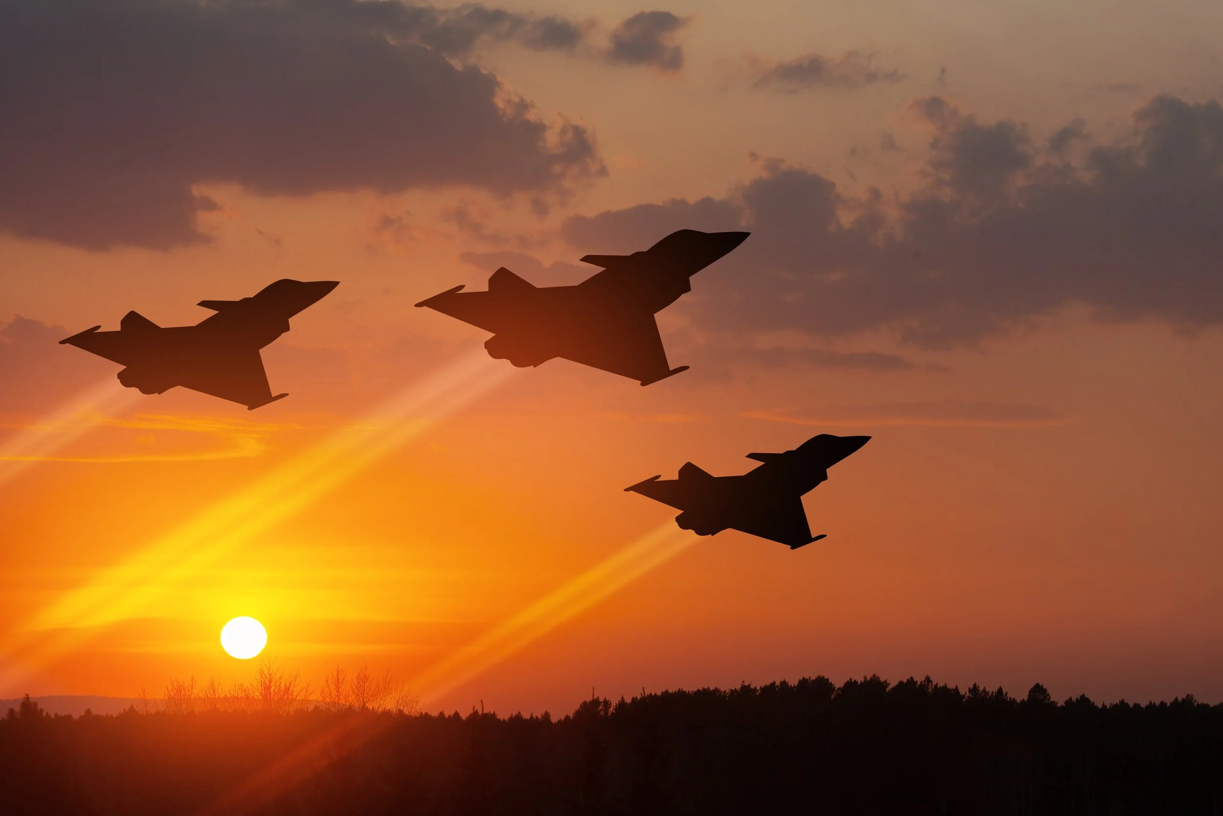 3 jets silhouetted against a golden sunset