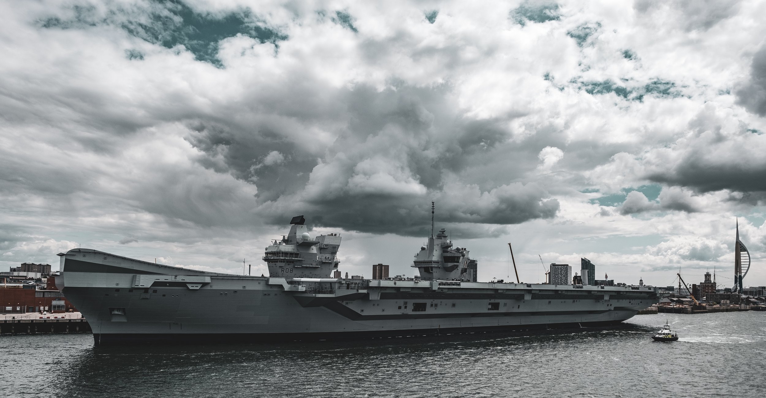 Grey battleship against a grey sky and sea.