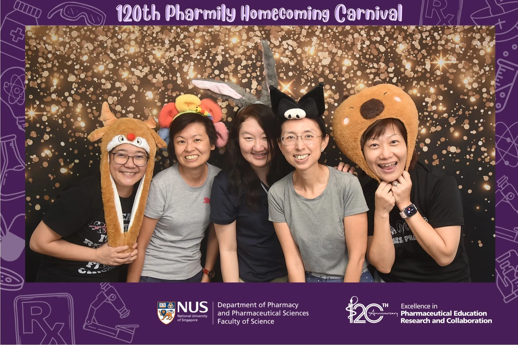 Five women standing side by side, smiling at the camera, wearing fun animal-themed hats, with a dark background filled with gold sparkles and a purple border featuring pharmacy-related icons. Text at the top reads '120th Pharmily Homecoming Carnival,