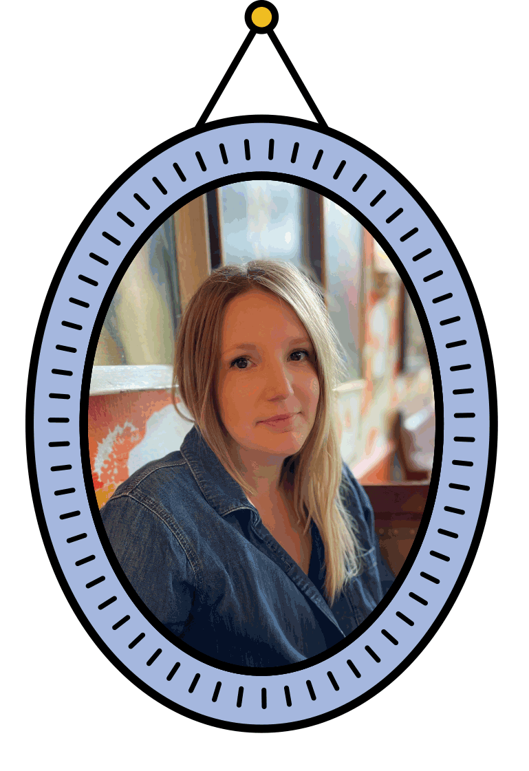 A photo of the designer Gem, with blonde hair wearing a denim shirt sitting indoors with a blurred background, sitting in an illustrated oval-shaped photoframe hanging on a wall.