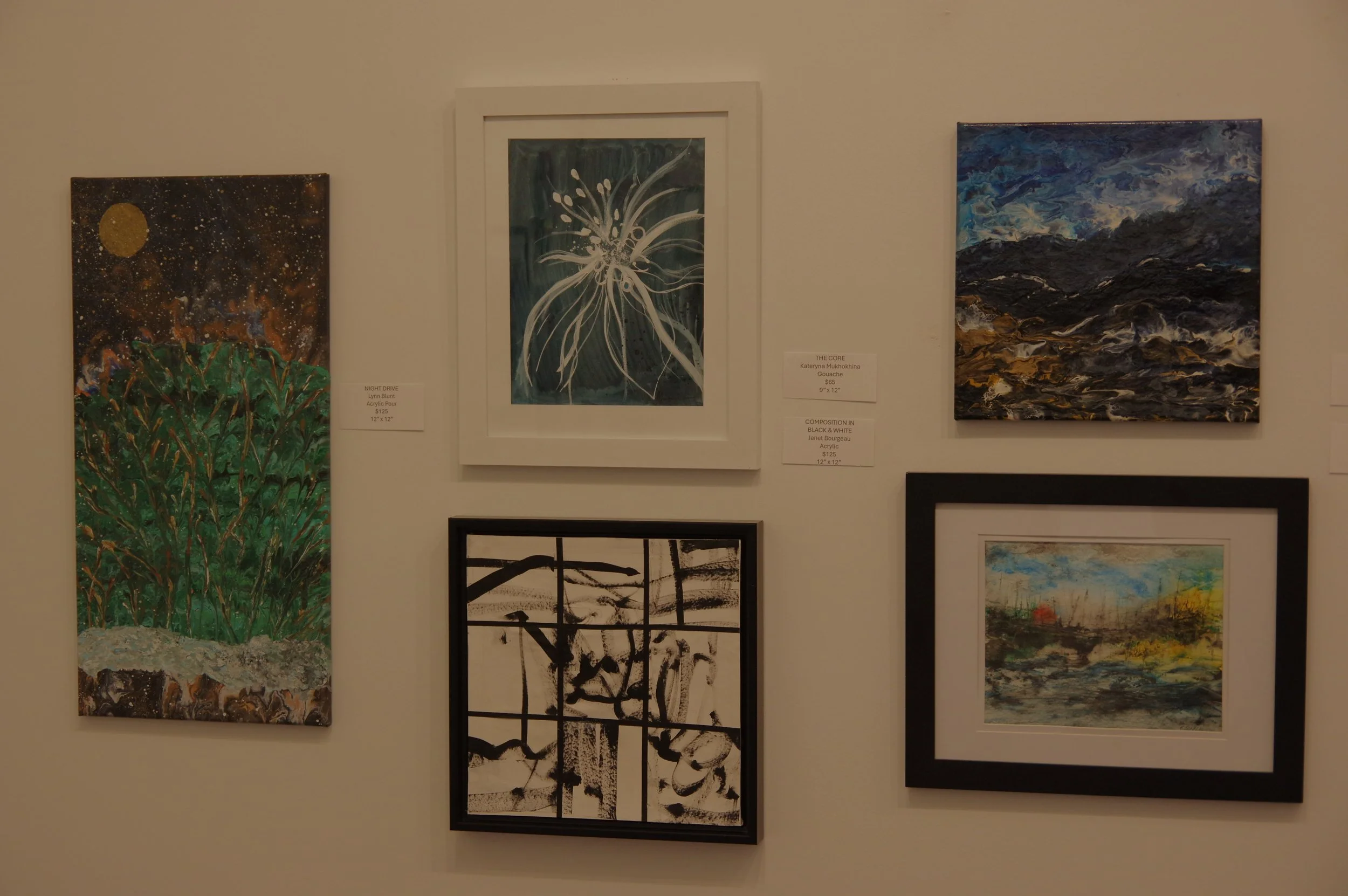 Gallery wall with five framed abstract art paintings of various sizes and styles.