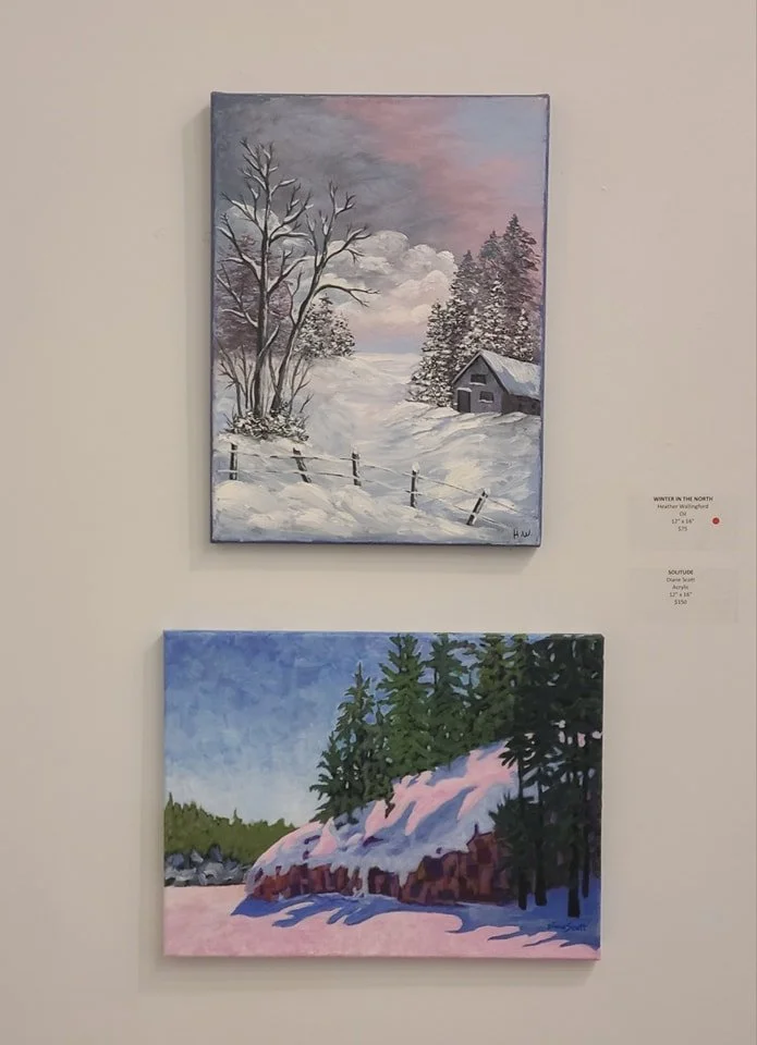 Two winter landscape paintings, one above the other, display snowy scenes with trees and cabins.