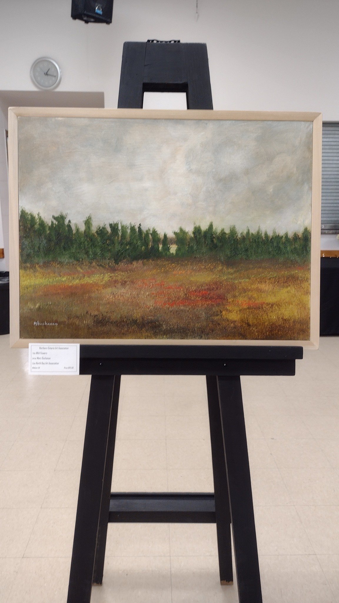 A landscape painting of a field with red, yellow, and brown colors, green trees in the background, and a cloudy sky.